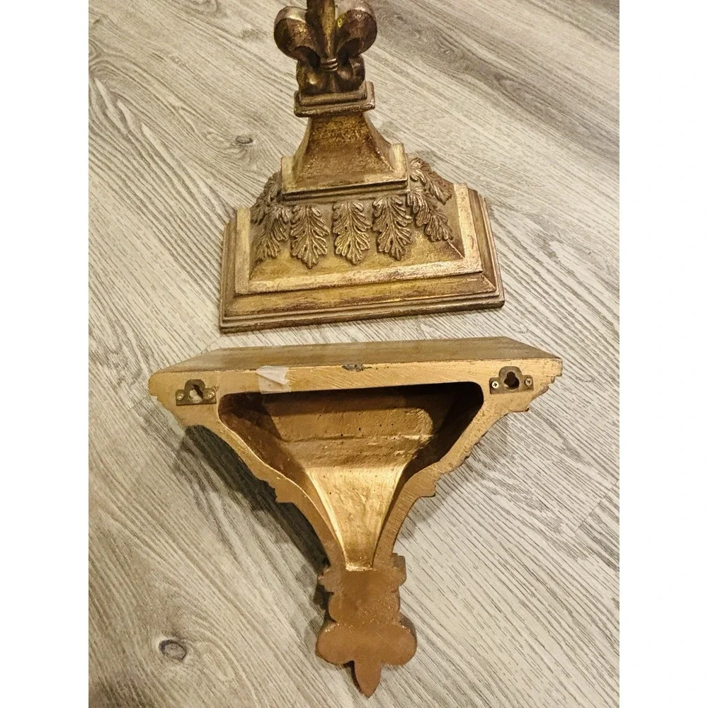 Vintage gold-toned decorative wall shelves with floral motifs.